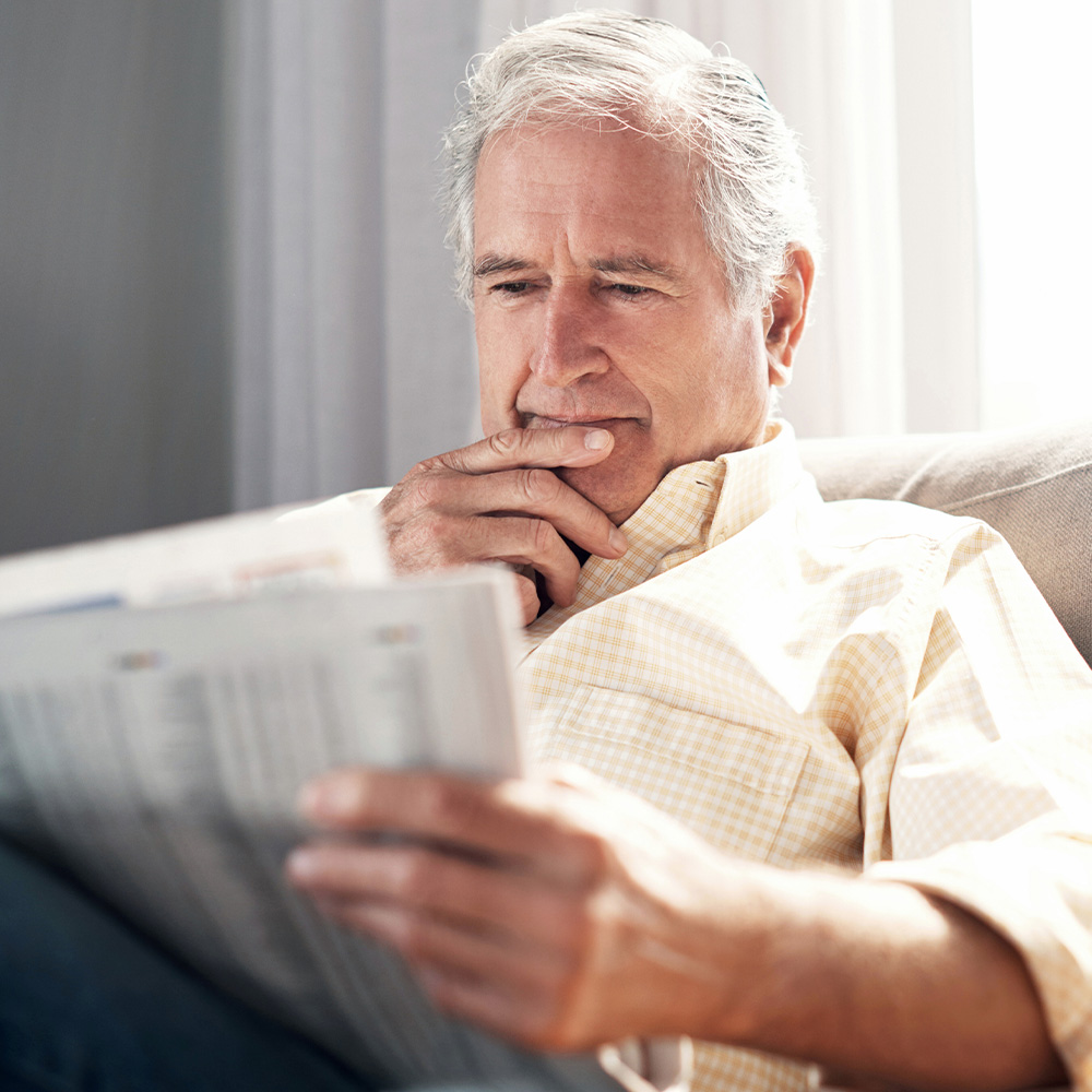 Older man reading a newspaper — glaucoma care