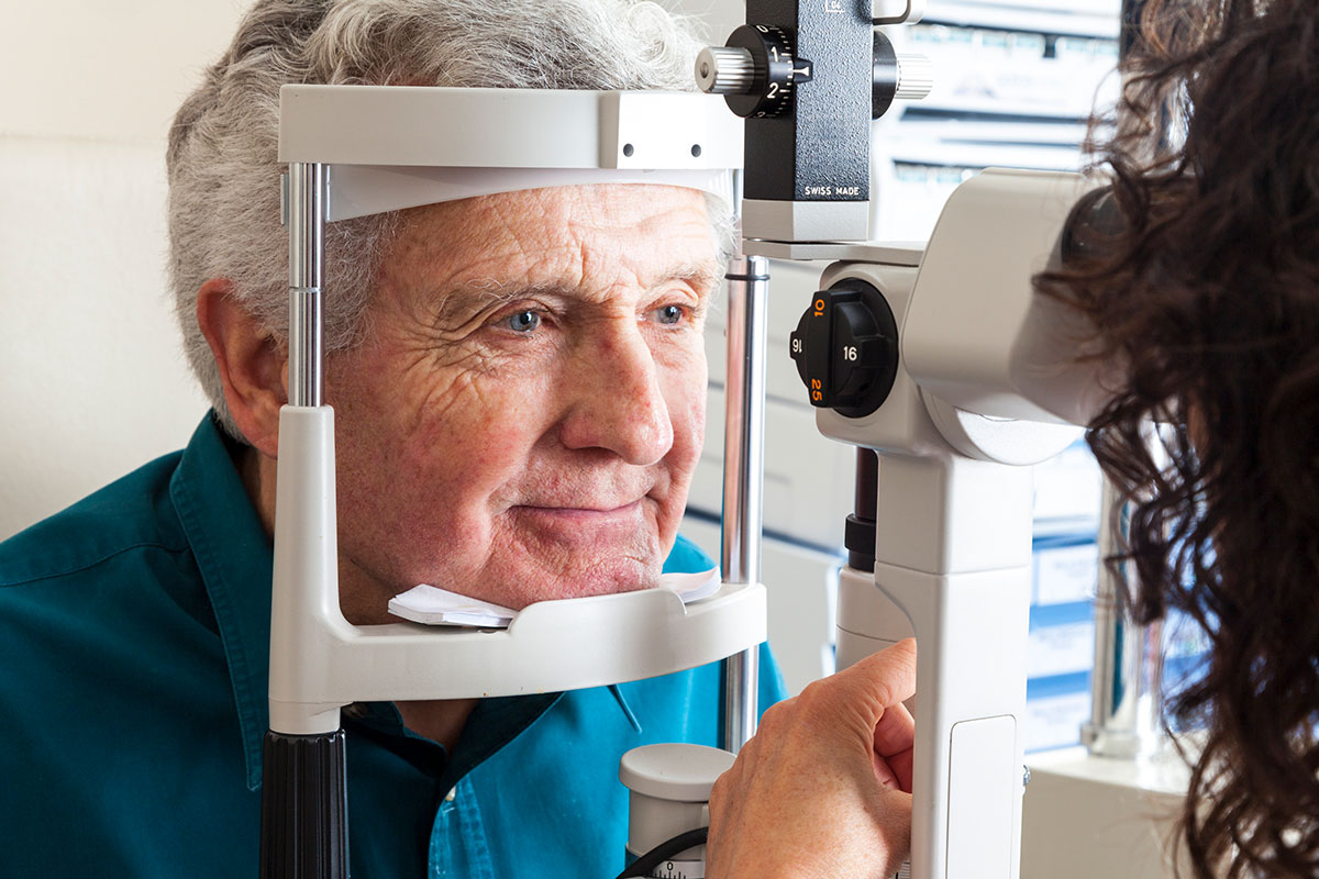 Older man having a slit lamp eye exam