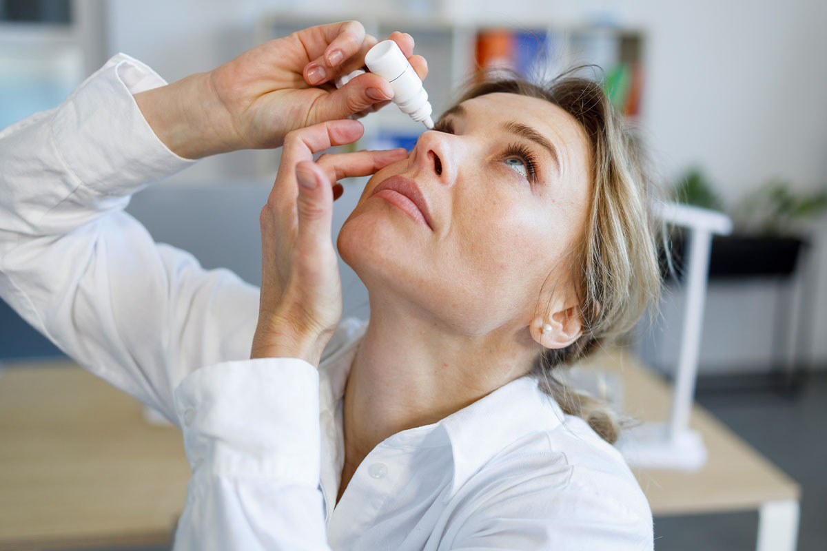 Woman receiving eye drops — red eye care