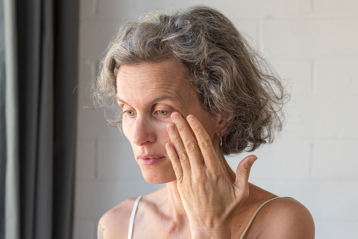 Woman touching her eyelid — eye discomfort evaluation